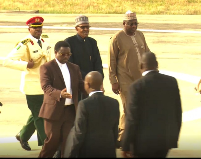 Buhari’s entourage leading him to the Presidential Villa