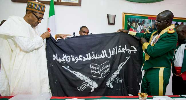 Buhari Receives Captured Boko Haram Flag, Tasks Military On Nigeria’s ...