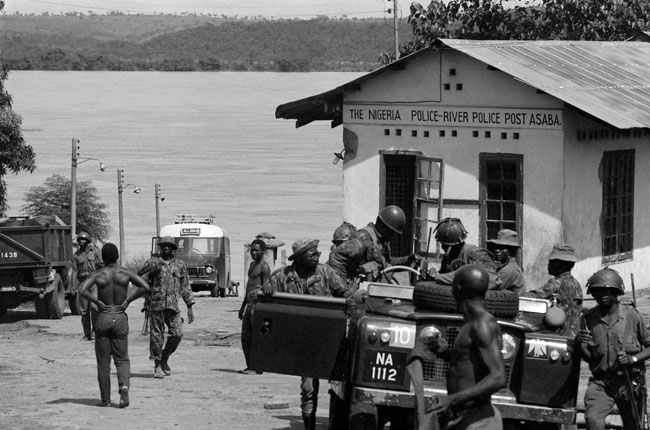 In this file photograph taken on October 28, 1967, Nigerian federal army soldiers survey a police checkpoint on the west bank of the Niger River at Asaba, from where they launched an amphibian offensive on Biafra, during the Biafran war. Colin HAYNES / AFP