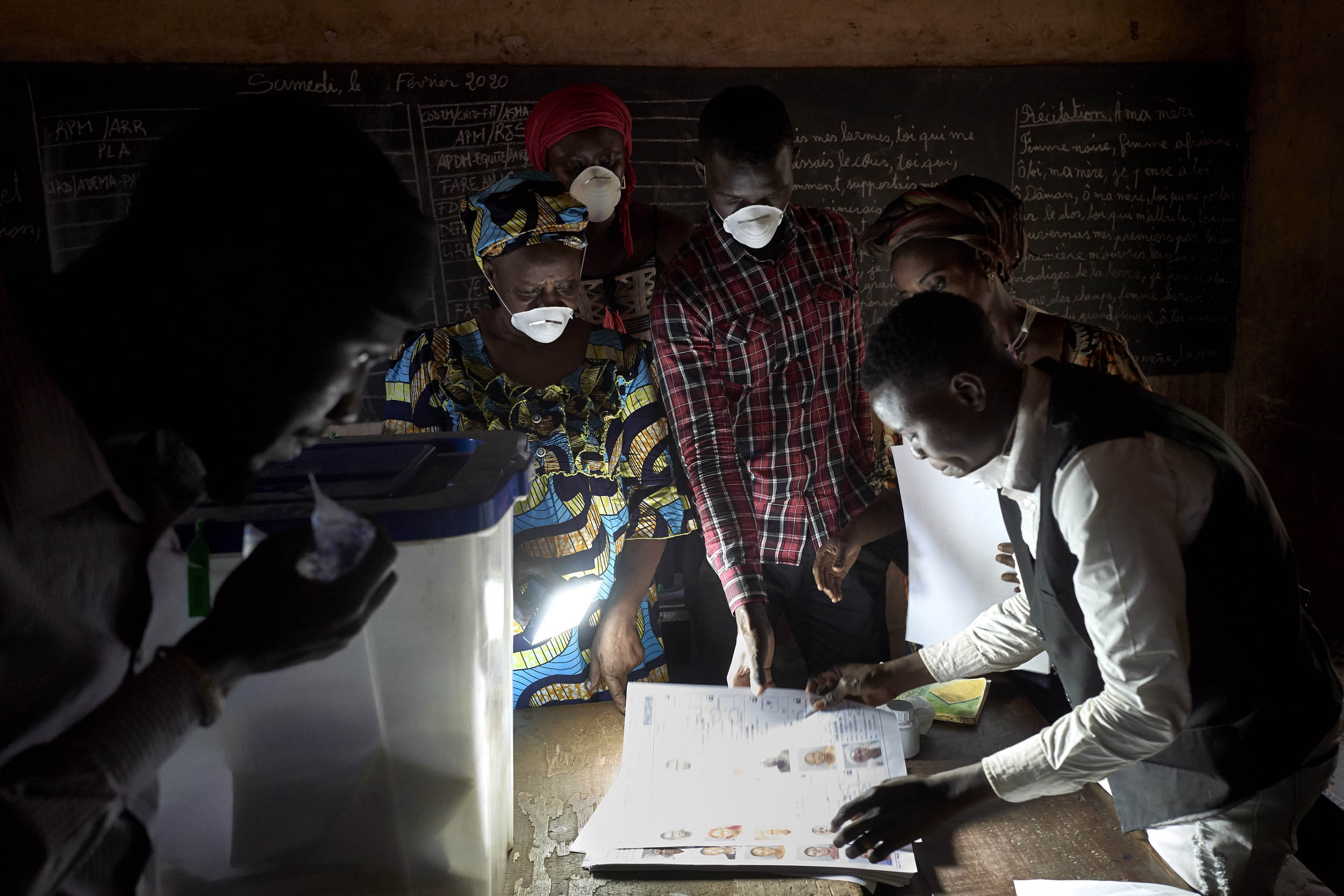 Electoral officials wearing masks as a preventive measure against the spread of the COVID-19 coronavirus count the votes at a polling station in Bamako on March 29, 2020. - Malians headed to the polls on March 29, 2020, for a long-delayed parliamentary election just hours after the country recorded its first COVID-19 coronavirus death and with the leading opposition figure kidnapped and believed to be in the hands of jihadists. Photo: Michele Cattani / AFP