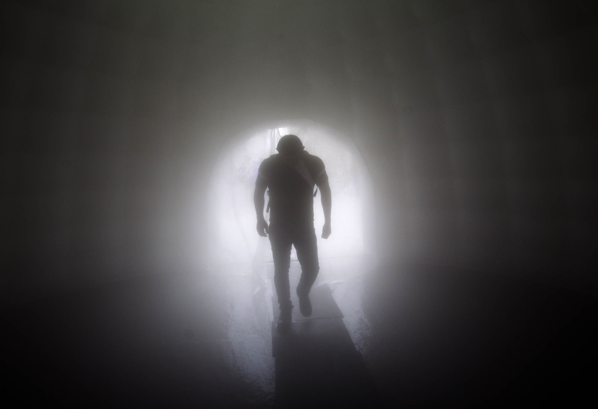 A man walks through a sanitizing tunnel installed outside a subway station in Escobedo, Nuevo Leon, Mexico, on March 29, 2020 as a preventive measure against the spread of the new coronavirus, COVID-19. - The smart cabin consists of an inflatable unit in a circular shape that is permanently spraying a sanitizing product used in hospitals. Photo: Julio Cesar Aguilar