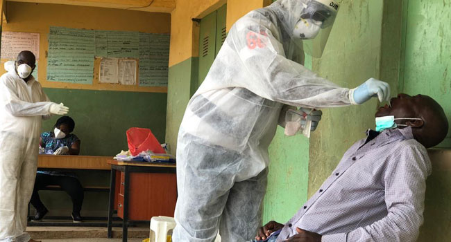 A medical official performs a throat swab on a resident of Mabushi in Nigeria’s Federal Capital Territory Abuja as part of the community testing for COVID-19… on Wednesday, April 15, 2020. Photo: Sodiq Adelakun/Channels TV