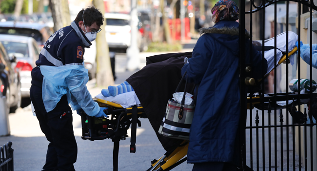 Health workers carry a patient to an ambulance on April 11, 2020 in the Brooklyn borough of New York City. Spencer Platt/Getty Images/AFP