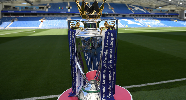 In this file photo taken on August 12, 2017 The Premier league trophy sits beside the pitch ahead of the English Premier League football match between Brighton and Hove Albion and Manchester City at the American Express Community Stadium in Brighton. CHRIS J RATCLIFFE / AFP