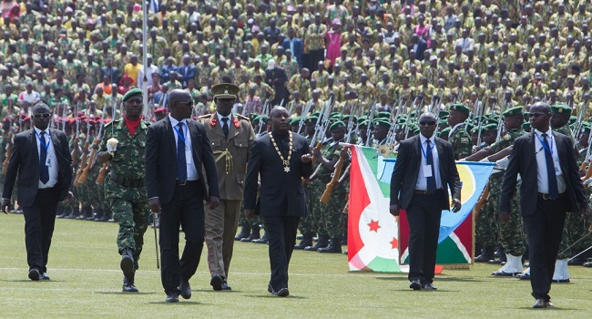 Evariste Ndayishimiye (3rd R), Burundi's elected President from the ruling party, the National Council for the Defense of Democracy - Forces for the Defense of Democracy (CNDD-FDD), walks in front of members of Burundi's army during the swearing-in ceremony at Ingoma stadium in Gitega, Burundi, on June 18, 2020. - Ndayishimiye rapidly sworn in following the sudden death of President Pierre Nkurunziza, aged 55, came after the May election. (Photo by TCHANDROU NITANGA / AFP)