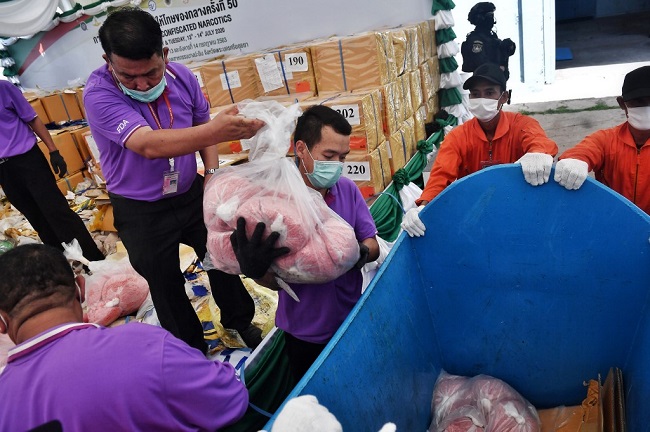 Thai Food and Drug Administration employees put heroin in a trolley to be incinerated to mark the United Nations' International Day against Drug Abuse and Illicit Trafficking at the Bang Pa-In industrial estate in Ayutt