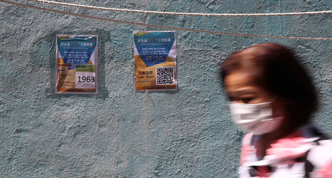 This file photo taken on July 11, 2020 shows information posters posted on a wall at a New Territories East polling station during a primary election in Hong Kong. May JAMES / AFP