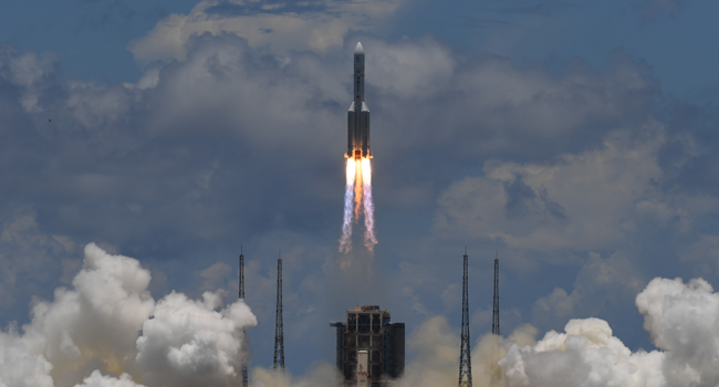 A Long March-5 rocket, carrying an orbiter, lander and rover as part of the Tianwen-1 mission to Mars, lifts off from the Wenchang Space Launch Centre in southern China's Hainan Province on July 23, 2020. Noel CELIS / AFP