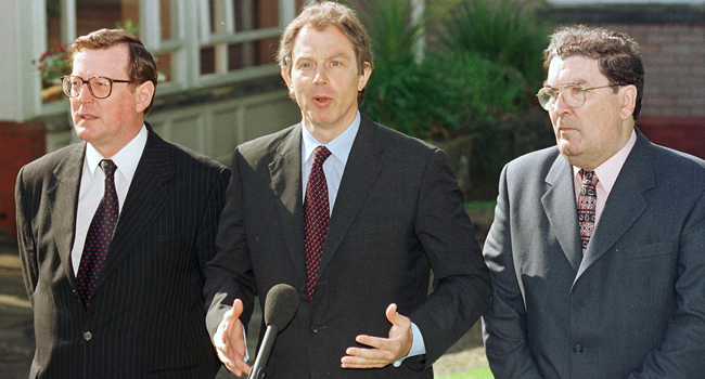 In this file photo taken on May 21, 1998 British Prime Minister Tony Blair (C) talks to the press after a meeting with and Ulster Unionist leader David Trimble (L) and SDLP leader John Hume to encourage a Yes vote for Friday's peace referendum. GERRY PENNY / AFP