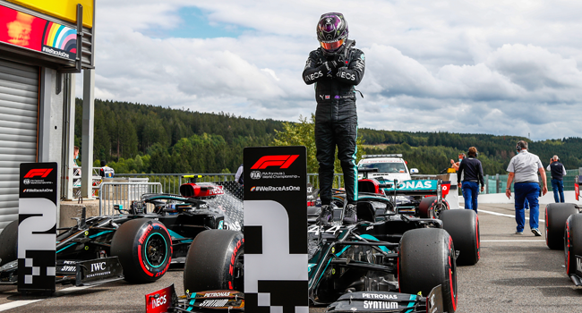 Mercedes' British driver Lewis Hamilton gestures in homage to late US actor Chadwick Boseman, as he stands on his car after securing his 93rd pole position during the qualifying session at the Spa-Francorchamps circuit in Spa on August 29, 2020 ahead of the Belgian Formula One Grand Prix. FRANCOIS LENOIR / POOL / AFP