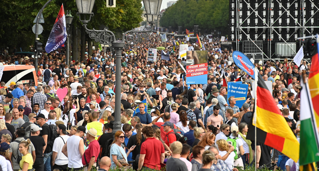 Participants wave national flags during a gathering on the 17. Juni avenue in Berlin at the end of a demonstration called by far-right and COVID-19 deniers to protest against restrictions related to the new coronavirus pandemic, on August 29, 2020. John MACDOUGALL / AFP