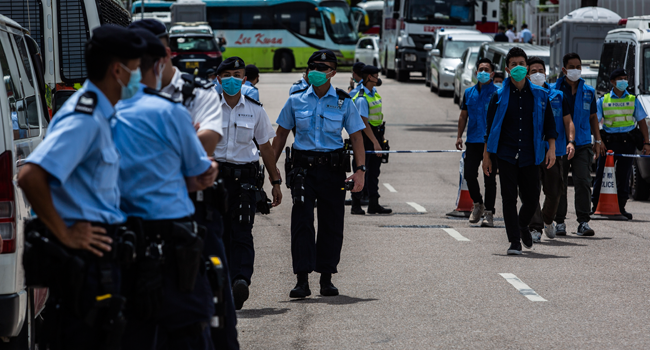 Police cordon off the street outside the Next Media publishing offices as authorities conduct a search of the premises after the company's founder Jimmy Lai was arrested under the new national security law in Hong kong on August 10, 2020. ISAAC LAWRENCE / AFP