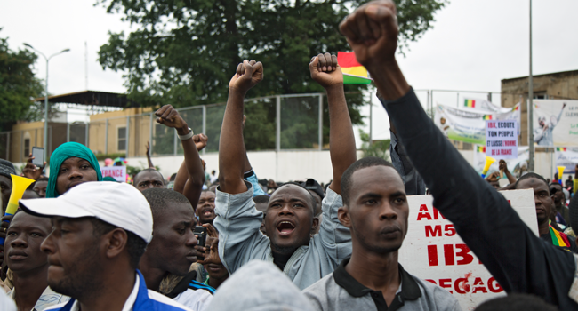 A man cheers during a protest organised by M5-RFP, who are calling for Malian President Ibrahim Boubacar Keita to resign, in Bamako on August 11, 2020.  ANNIE RISEMBERG / AFP