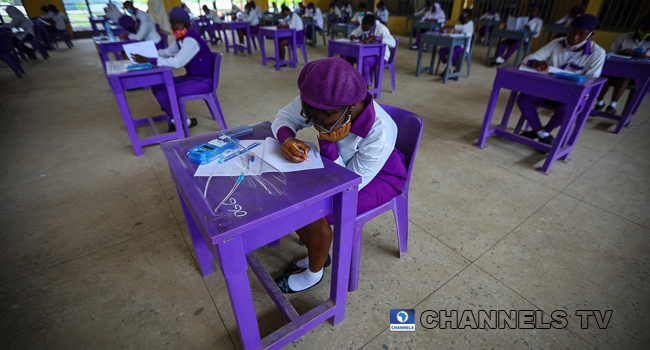 Wearing face-masks, final year students of Government Secondary School, Zone 3, Abuja, sit in a classroom as they write their West African Examinations Council exams, following the ease of COVID-19 lockdown order on Monday August 17, 2020. Photo: Sodiq Adelakun/Channels Television.