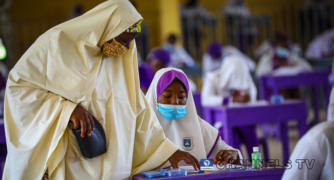 Wearing face-masks, final year students of Government Secondary School, Zone 3, Abuja, sit in a classroom as they write their West African Examinations Council exams, following the ease of COVID-19 lockdown order on Monday August 17, 2020. Photo: Sodiq Adelakun/Channels Television.