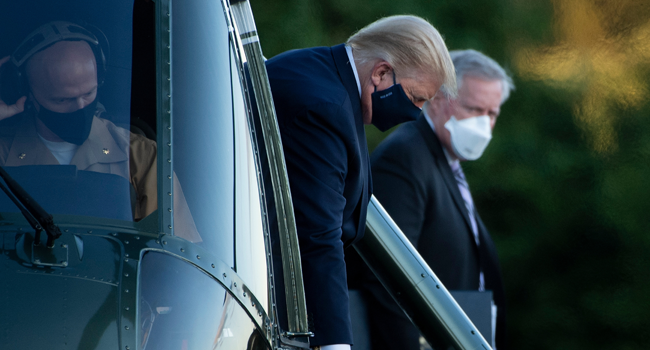 White House Chief of Staff Mark Meadows (R) watches as US President Donald Trump walks off Marine One while arriving at Walter Reed Medical Center in Bethesda, Maryland on October 2, 2020. Brendan Smialowski / AFP