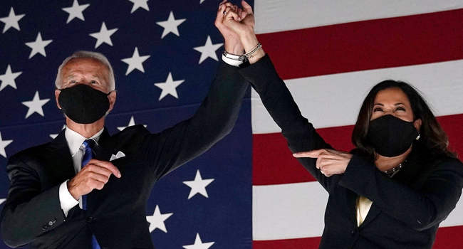 ) In this file photo taken on August 20, 2020 Former vice-president and Democratic presidential nominee Joe Biden (L) and Senator from California and Democratic vice presidential nominee Kamala Harris greet supporters outside the Chase Center in Wilmington, Delaware. Olivier DOULIERY / AFP