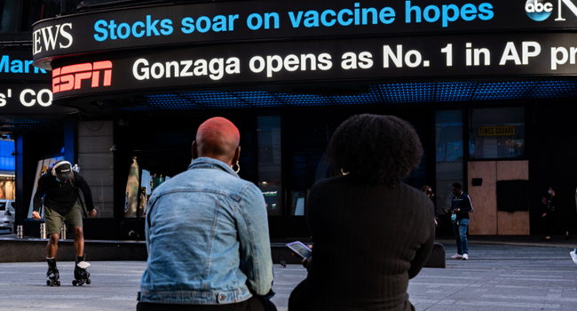 An electronic billboard in Times Square announces "stocks soar on vaccine hopes" on November 9, 2020 in New York City. David Dee Delgado/Getty Images/AFP