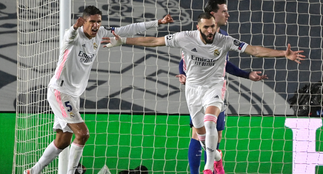 Real Madrid's French forward Karim Benzema (R) celebrates after scoring during the UEFA Champions League semi-final first leg football match between Real Madrid and Chelsea at the Alfredo di Stefano stadium in Valdebebas, on the outskirts of Madrid, on April 27, 2021. JAVIER SORIANO / AFP
