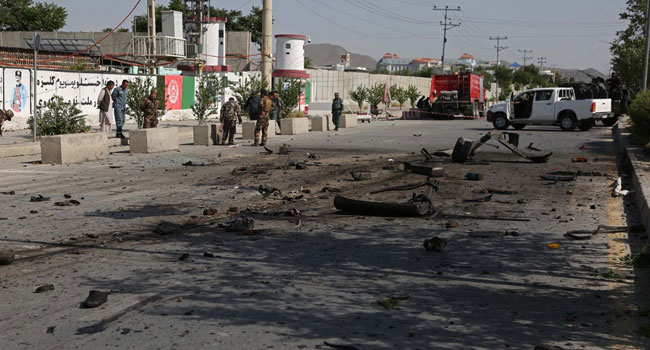 Security personnel stand at the site of an explosion in Kabul on June 3, 2021, after at least four people were killed and four others injured when a minibus was hit by an explosion in Kabul, according to police, in the latest attack on commuters in the Afghan capital. Zakeria HASHIMI / AFP