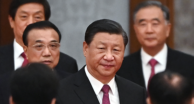 This file photo taken on September 30, 2021 shows China's President Xi Jinping (C) arriving with Premier Li Keqiang (L) for a reception at the Great Hall of the People in Beijing on the eve of China's National Day. GREG BAKER / AFP