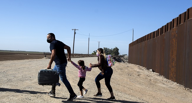 U.S. Customs agent David Gonzalez helps a traveler from Mexico use