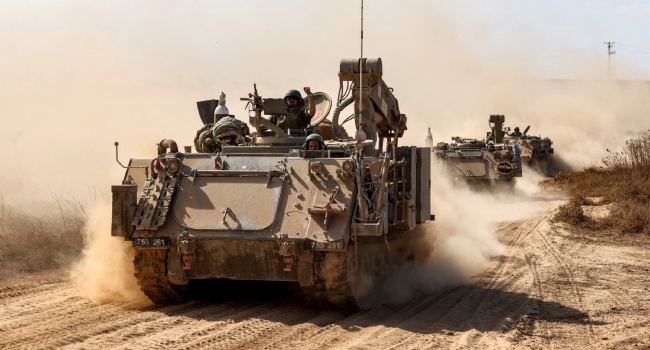 Israeli army infantry fighting vehicles (IFVs) deploy along the border with the Gaza Strip in southern Israel on October 13, 2023. Thousands of people, both Israeli and Palestinians have died since October 7, 2023, after Palestinian Hamas militants entered Israel in a surprise attack leading Israel to declare war on Hamas in the Gaza Strip enclave on October 8.