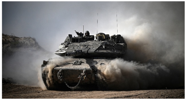 An Israeli army battle tank moves in an area along the border with the Gaza Strip and southern Israel on April 2, 2024 amid the ongoing conflict in the Palestinian territory between Israel and the militant group Hamas. (Photo by RONALDO SCHEMIDT/AFP)